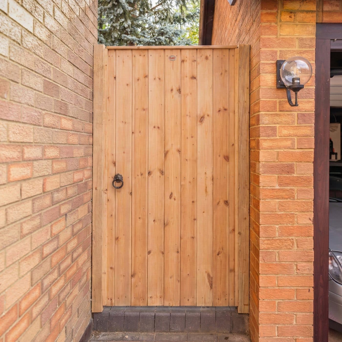 A made-to-measure wooden driveway gate