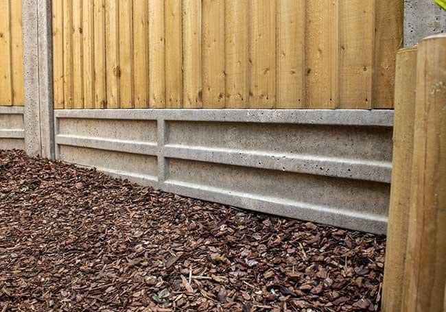 Concrete fence posts with gravel boards